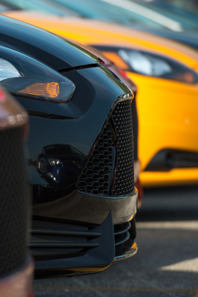 front end of sedans lined up on a car lot