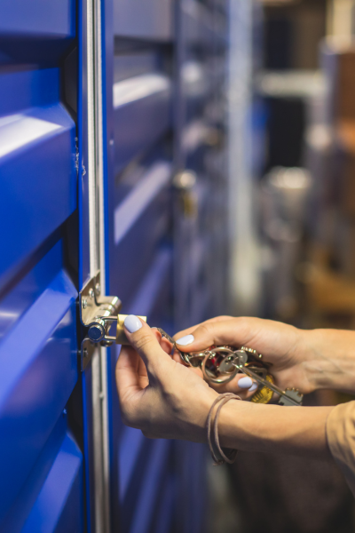 woman locking a self-storage unit