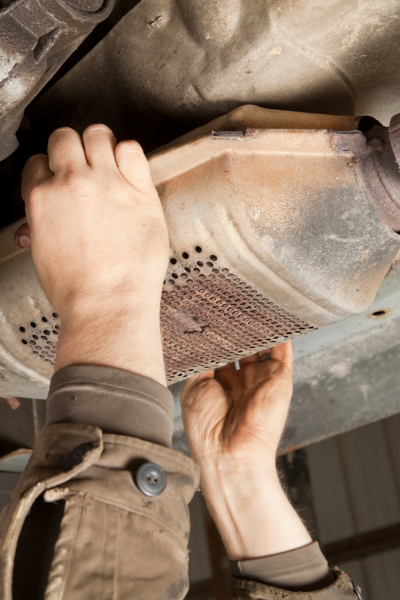 image of someone removing a catalytic converter one of the biggest security risks in the auto industry