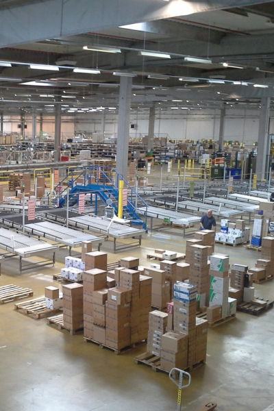 photo showing a large warehouse with boxes and conveyor belts